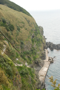 The sheer dropoff from Jukdo Islet's West bank means a smal cable car and a spiral cement staircase are needed to scale the rock face