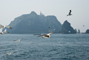 Hole Rock, seagulls, a fishing boat and Dokdo's East Islet